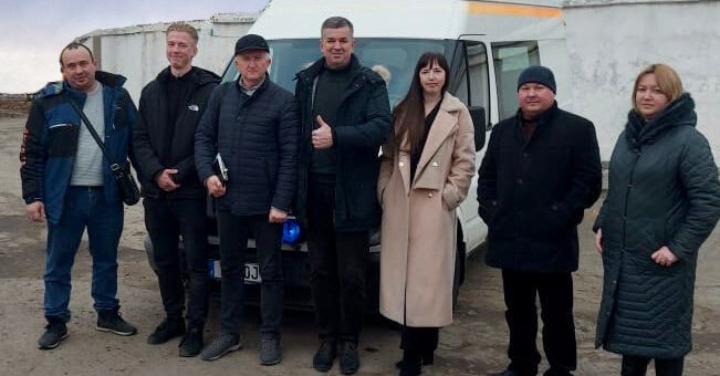 Михайло Линецький та група людей біля білого мікроавтобуса