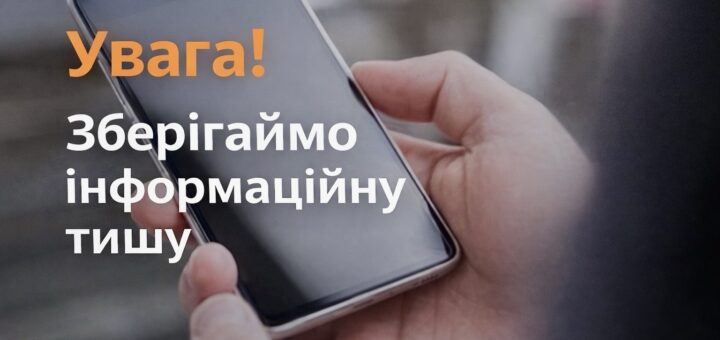 Людина тримає смартфон у руках, поверх зображення текст українською: “Увага! Зберігаймо інформаційну тишу”